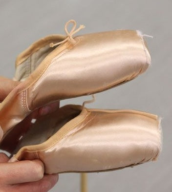 pair of satin ballet pointe shoes closeup